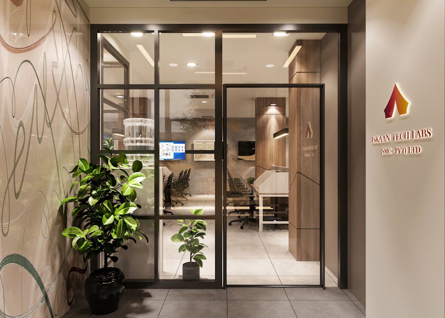 Stylish office entrance with glass door and company signage, featuring elegant decor and indoor plants